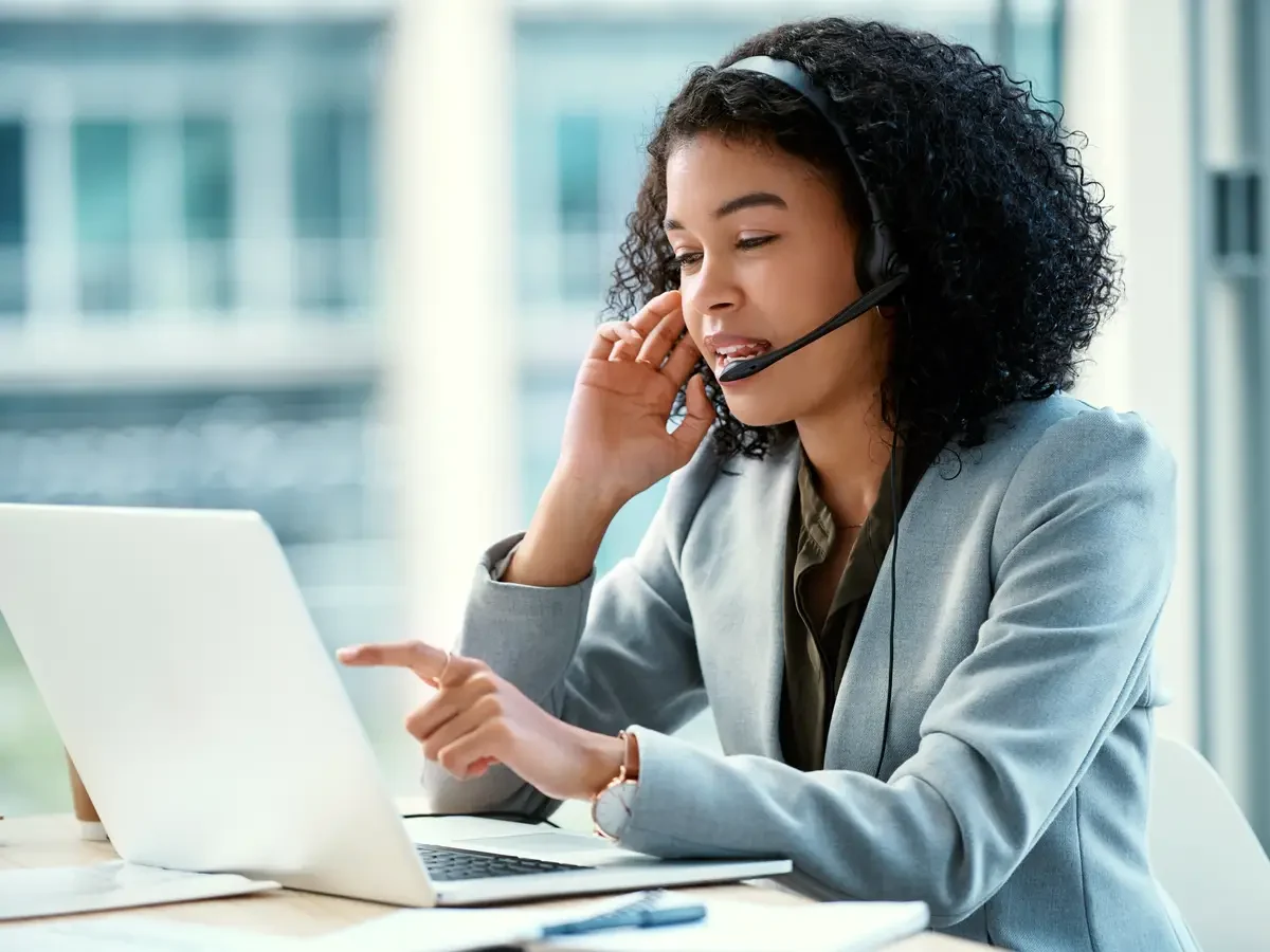 Professional at a laptop accompanying telephone language and translation services