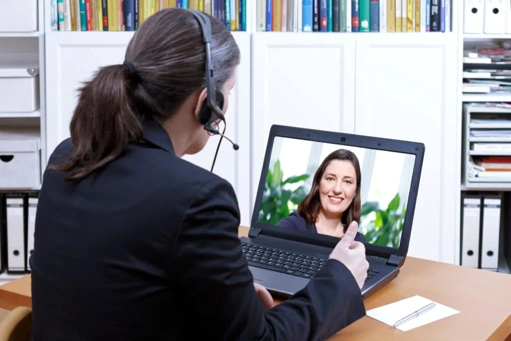 Laptop video call accompanying remote language and translation services Laptop video call accompanying remote language and translation services